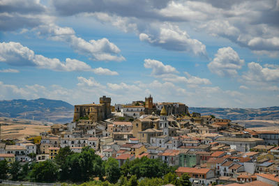 Buildings in town against sky