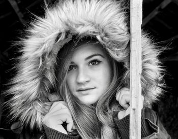 Portrait of young woman wearing fur coat