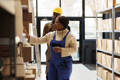 Side view of young woman standing in store