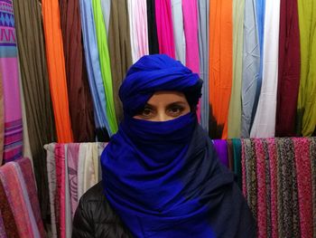 Midsection of man wearing multi colored mask