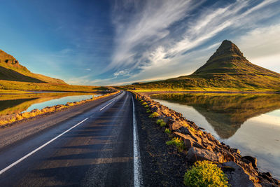 Panoramic view of road leading towards mountains against sky