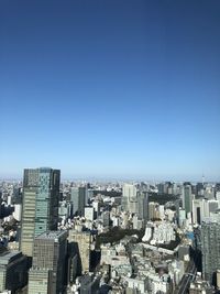 Cityscape against clear blue sky