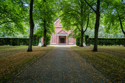 Footpath amidst trees and building
