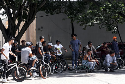 People sitting on street in city