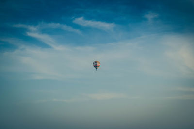 Low angle view of person paragliding against sky