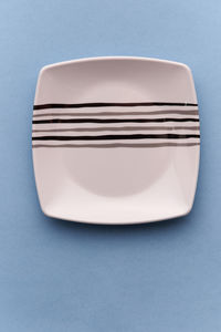 Directly above shot of plate on blue background
