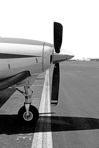 Airplane on runway against clear sky