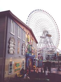 Low angle view of ferris wheel against sky