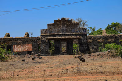 Old ruin building against clear blue sky