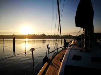 Boats sailing on sea against sky during sunset