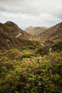 Scenic view of mountains against cloudy sky