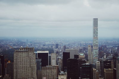 Cityscape against cloudy sky