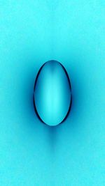 Close-up of blue object over black background