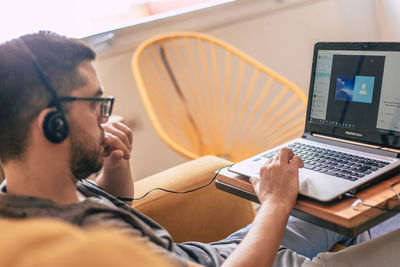 Man using laptop at home