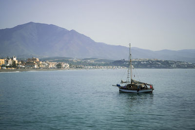 Sailboat sailing on sea against sky