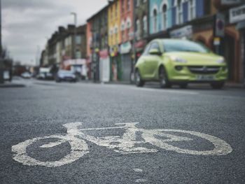 Close-up of cars on road in city