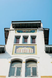 Low angle view of building against clear blue sky