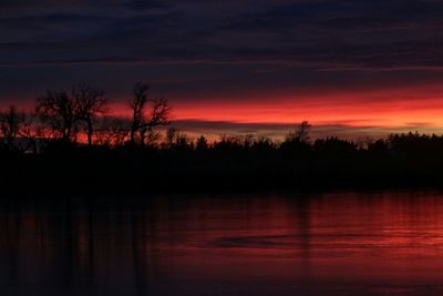 Scenic view of lake against sky at sunset