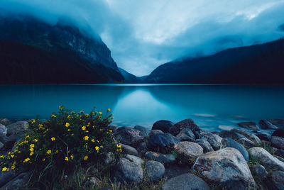 Scenic view of lake and rocks against sky