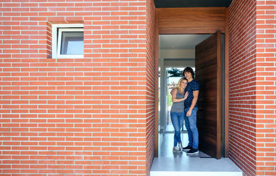 Loving couple standing at doorway