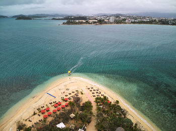 High angle view of beach and sea with boat fetching tourists