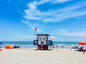 Lifeguard hut on beach against sky