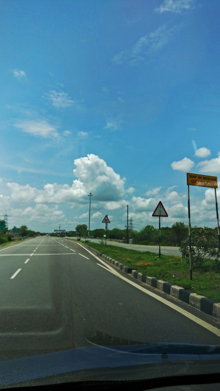 ROAD SEEN THROUGH CAR WINDSHIELD