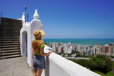 Girl enjoying panoramic view of vitoria metropolitan region, vila velha, espirito santo, brazil