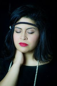 Close-up portrait of young woman with eyes closed