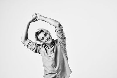 Portrait of smiling man standing against white background