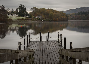 Jetty on lake against sky