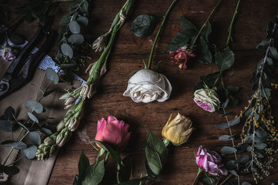 High angle view of red rose on wooden table