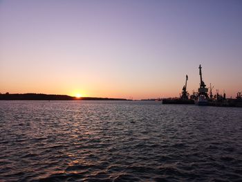 Scenic view of sea against clear sky during sunset