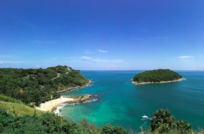 Scenic view of bay against clear blue sky