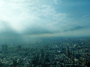 High angle view of city against cloudy sky