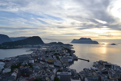 Scenic view of sea against cloudy sky during sunset