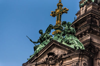 Low angle view of statue against clear blue sky