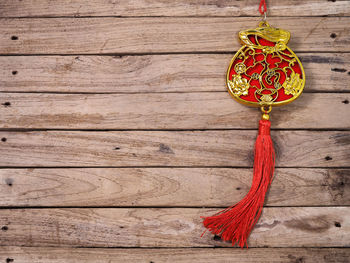 Close-up of decoration hanging on rope against wall