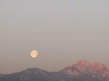 Scenic view of mountains against clear sky at night