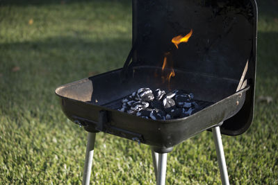 Close-up of burning on barbecue grill in yard