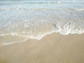 High angle view of waves rushing towards shore