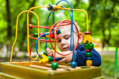 Portrait of cute boy playing with toy