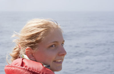 Close-up of smiling woman looking away