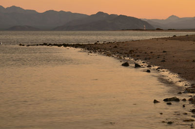 Distant lighthouse on dusk shoreline sea of cortez, bahia de los angeles, baja, mexico