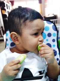 Close-up portrait of cute boy eating