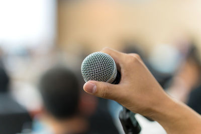 Close-up of hand holding microphone