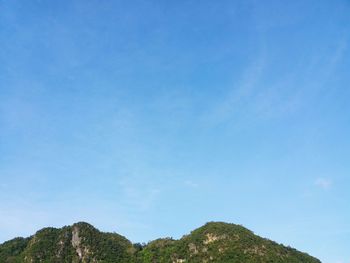 Low angle view of mountain against blue sky