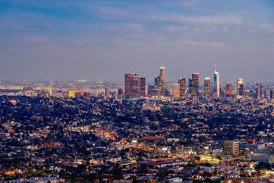 Aerial view of modern buildings in city against sky