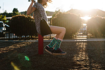 Side view of girl swinging at playground