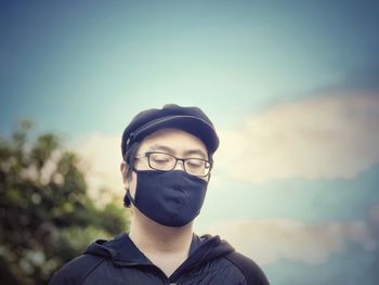 Portrait of young man standing against sky during sunset